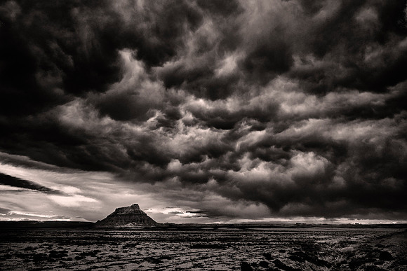 Factory Butte, UT, at sunset.  Factory Butte is a 6,302-foot summit in the Upper Blue Hills in northern Wayne County, Utah,