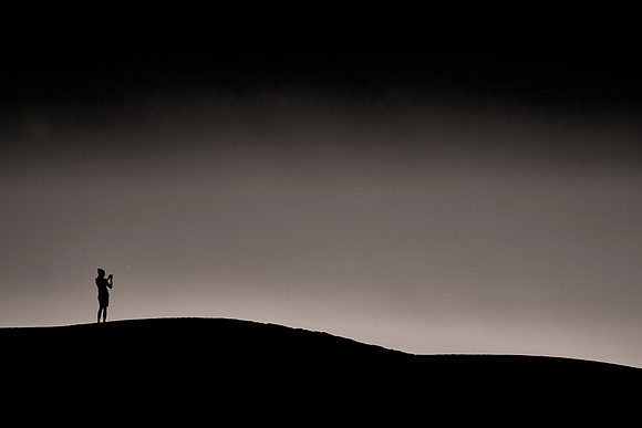Astrophotographer at sunset over White Sands National Monument, New Mexico